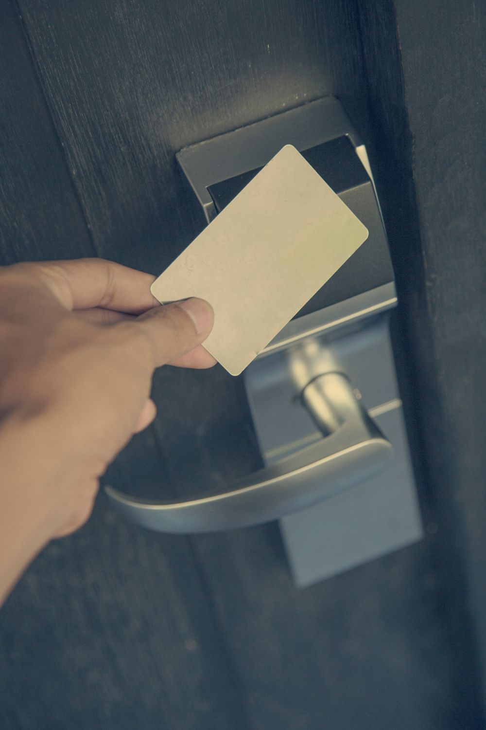 A hotel keycard tapped on electronic lock.